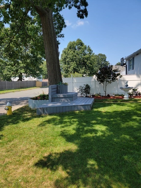 192 Starling Road Springfield, MA 01119 - Photo 4 of 26 a view of a patio with table and chairs potted plants and palm tree