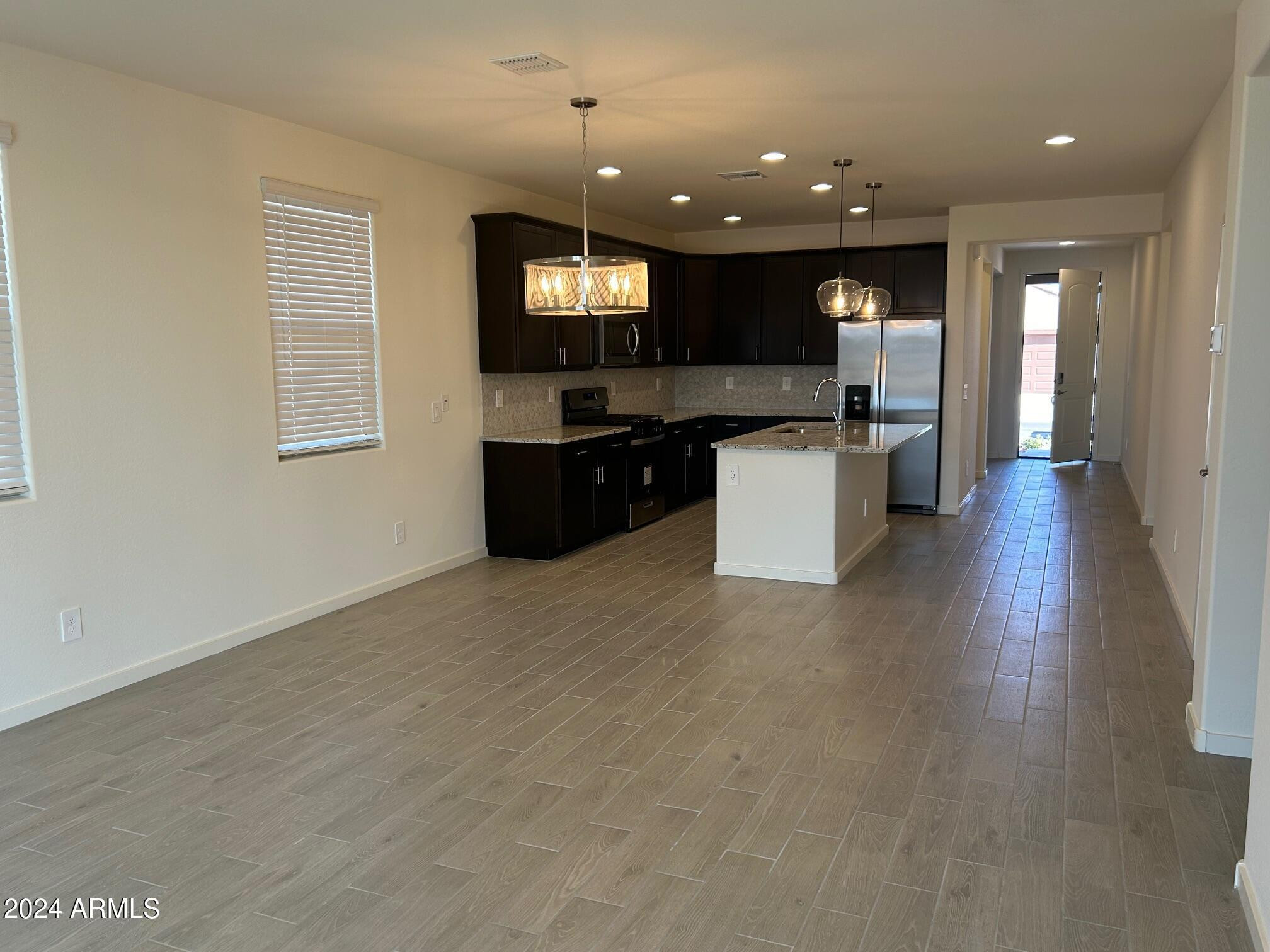 20520 North Candlelight Road Maricopa, AZ 85138 - Photo 5 of 18 a kitchen with a sink cabinets and wooden floor