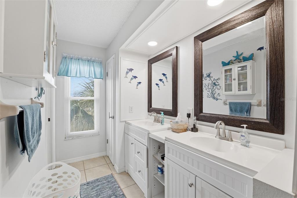 3366 Bluefish Drive Hernando Beach, FL 34607 - Photo 15 of 75 a bathroom with double vanity sink a mirror and a shower
