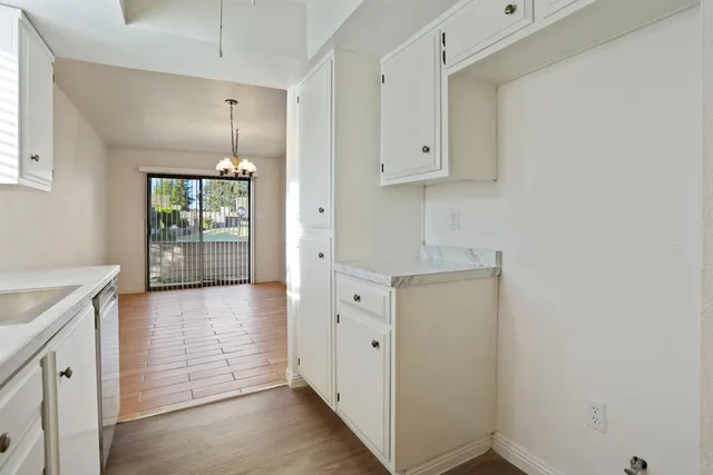 a view of a kitchen with white cabinets