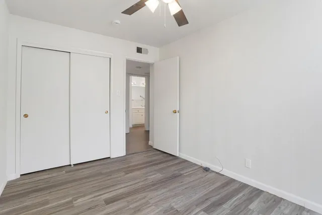a view of empty room with wooden floor