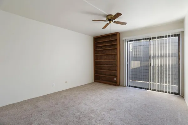 a view of room with stairs and a ceiling fan