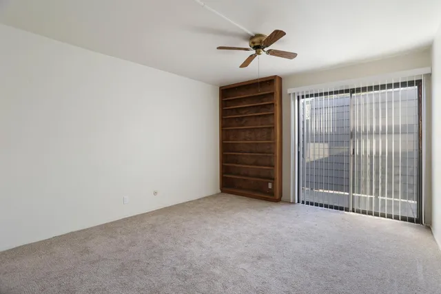 a view of room with stairs and a ceiling fan