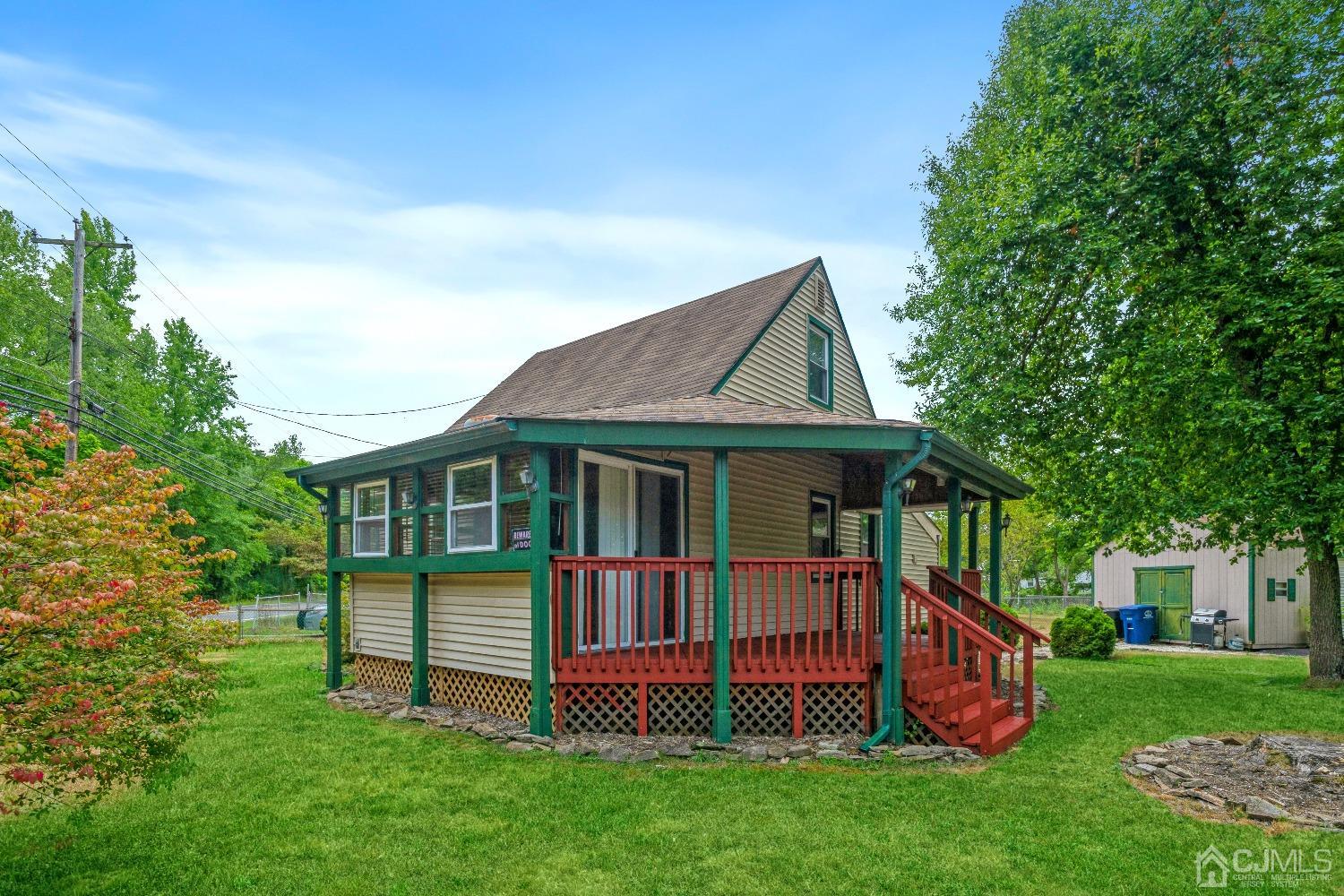 1100 Junction Road Browns Mills, NJ 08015 - Photo 2 of 27 a view of a house with a yard and a deck