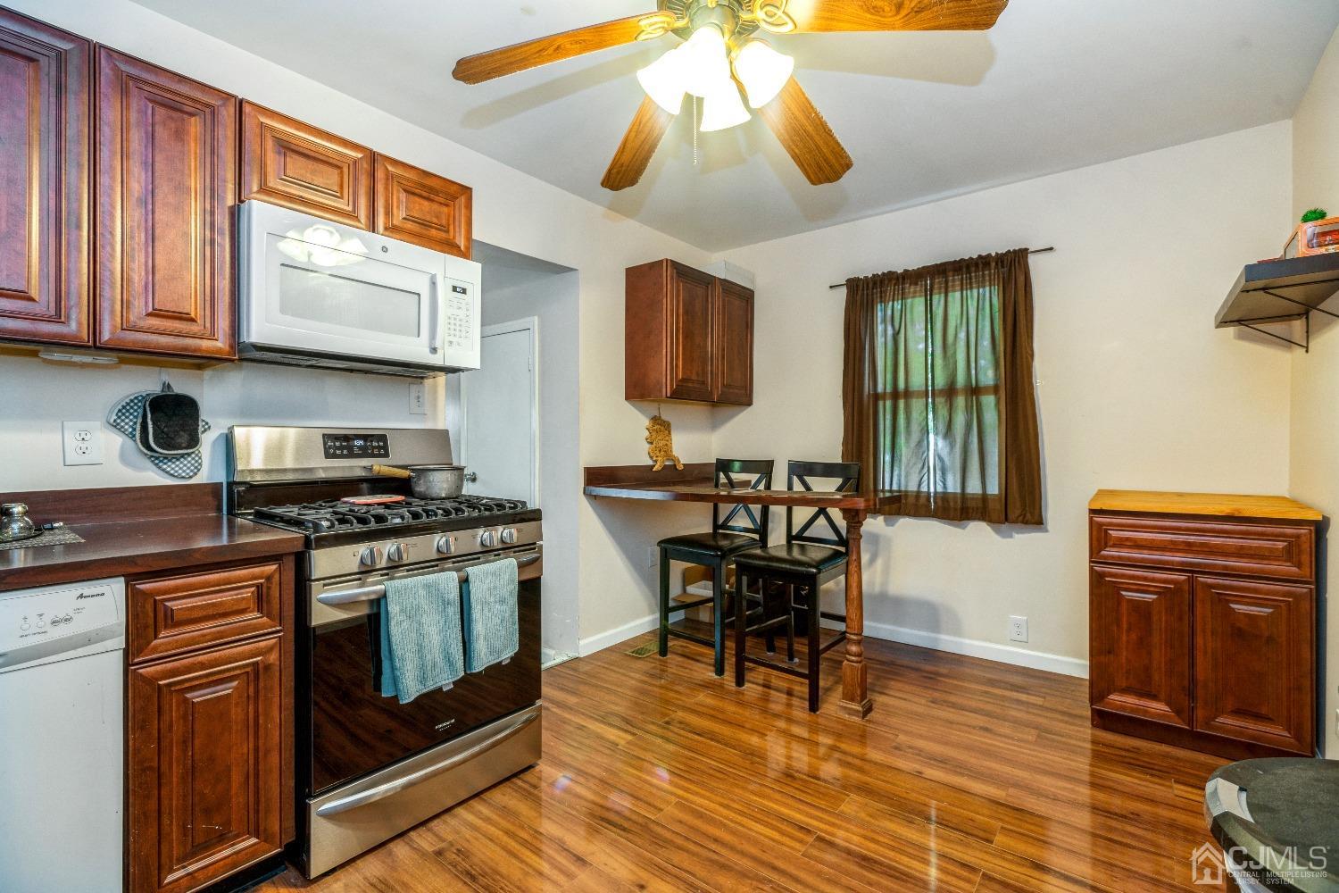 1100 Junction Road Browns Mills, NJ 08015 - Photo 6 of 27 a kitchen with stainless steel appliances granite countertop a stove and a wooden cabinets