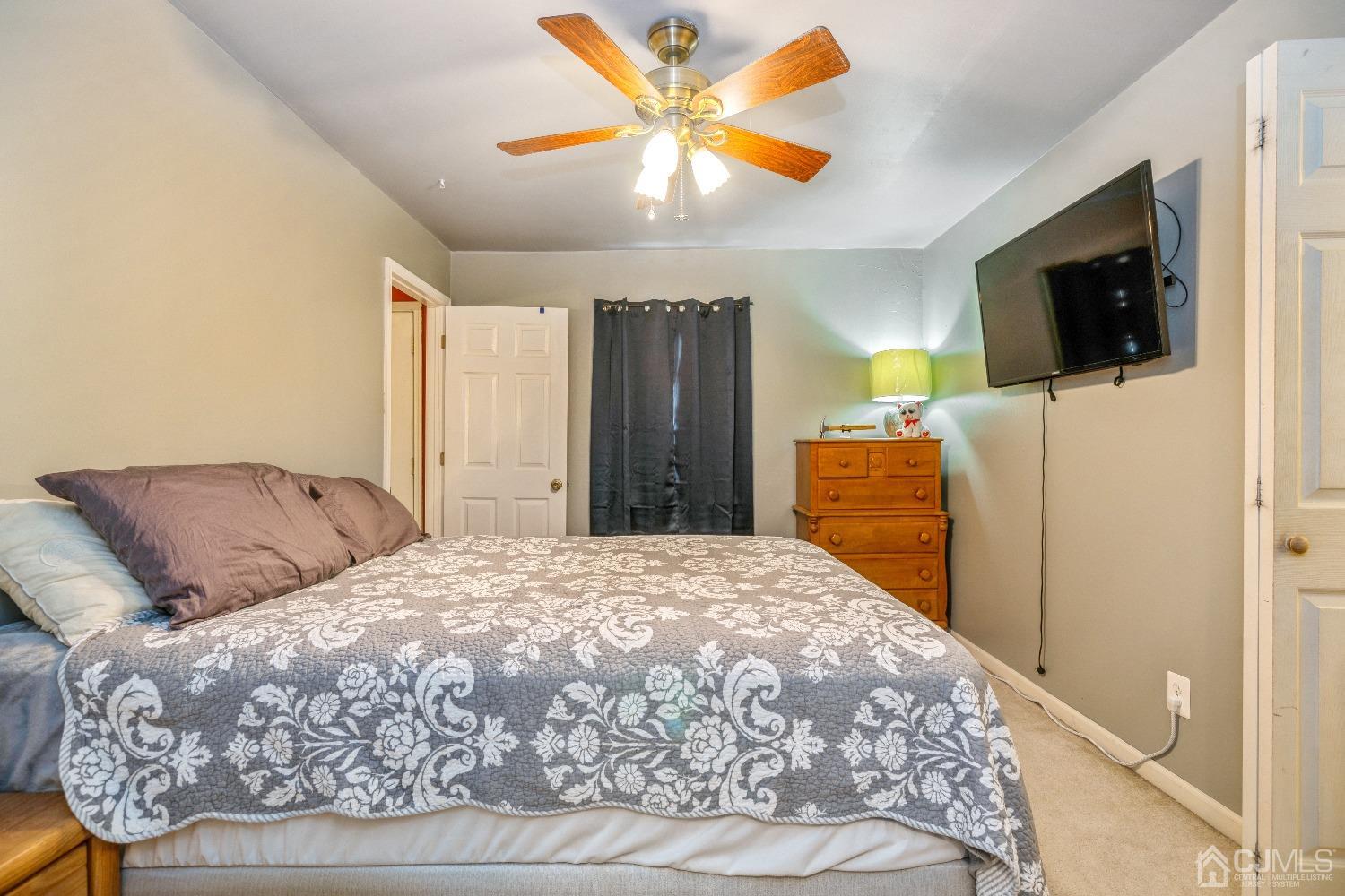 1100 Junction Road Browns Mills, NJ 08015 - Photo 10 of 27 a bedroom with a large bed and a flat screen tv