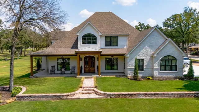 a front view of house with yard and green space