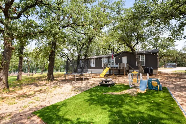 a view of a house with backyard porch and sitting area