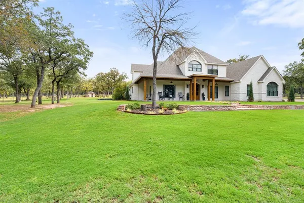 a front view of house with yard and green space