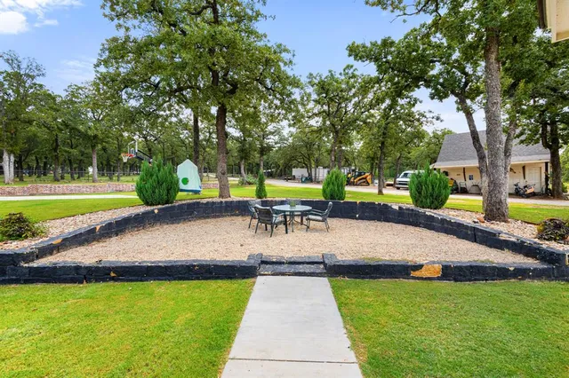 a view of a swimming pool with a patio and a yard