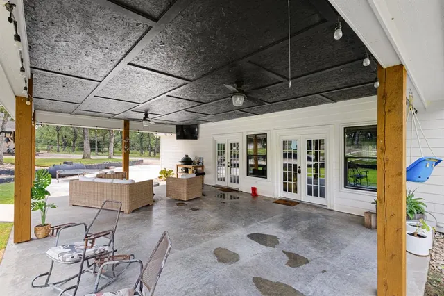 a building outdoor space with patio furniture and potted plants