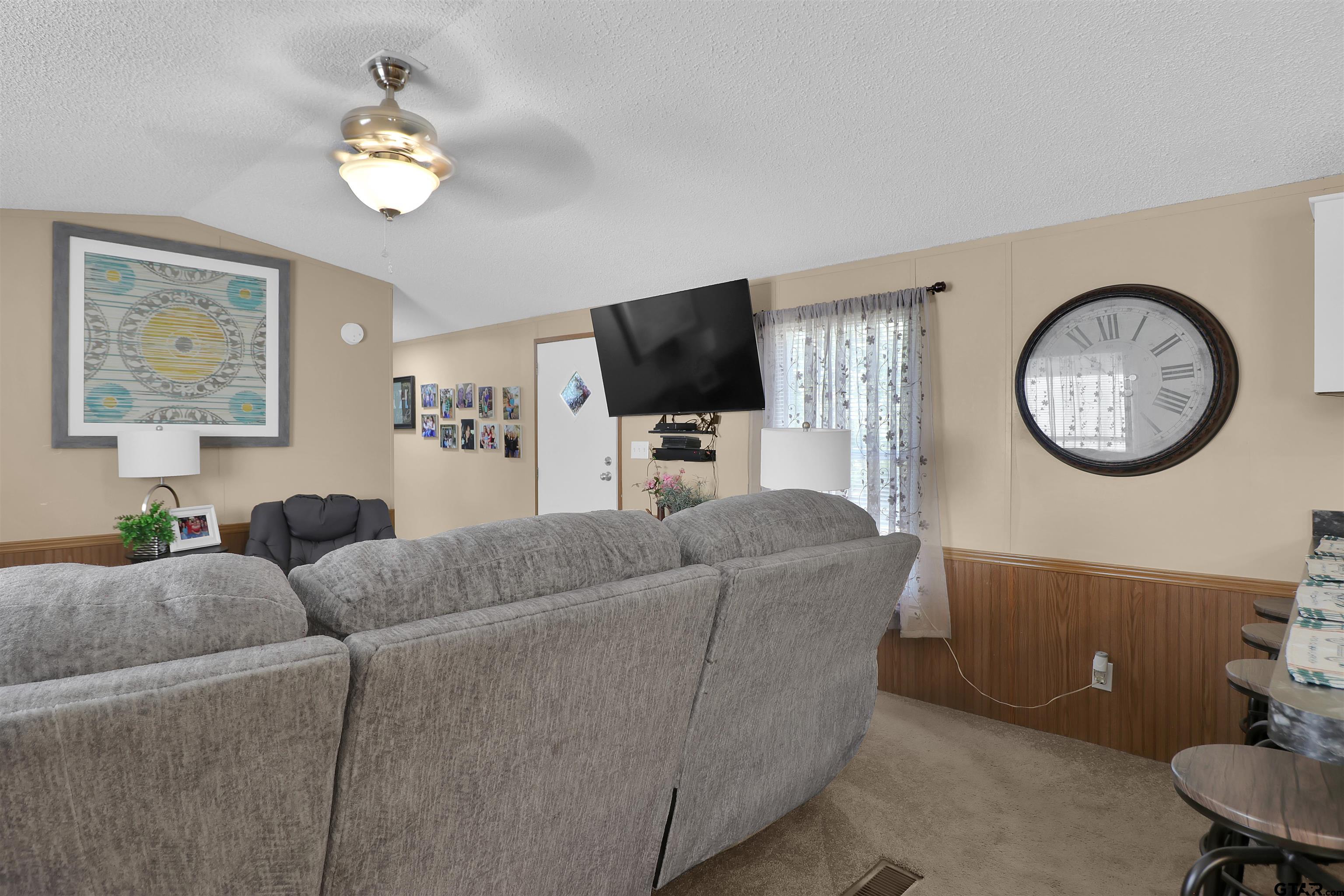 602 North Commerce Street Overton, TX 75684 - Photo 2 of 17 a living room with furniture and a flat screen tv