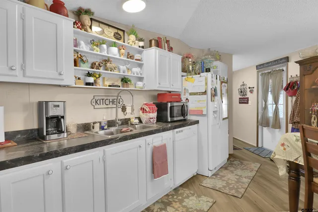 a kitchen with refrigerator and cabinets