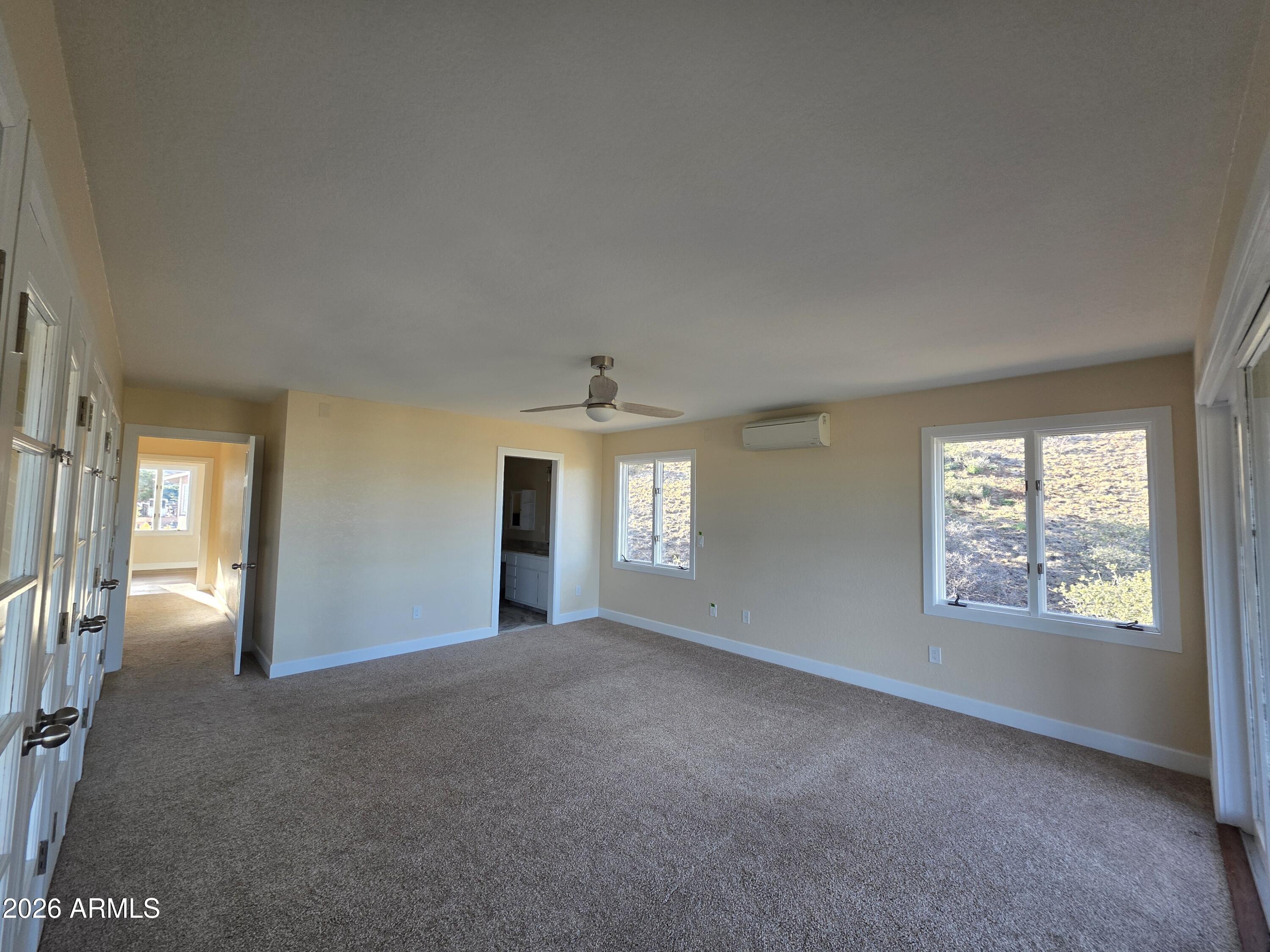 4880 Comanche Trail Prescott, AZ 86301 - Photo 26 of 44 a view of a big room with windows and chandelier fan