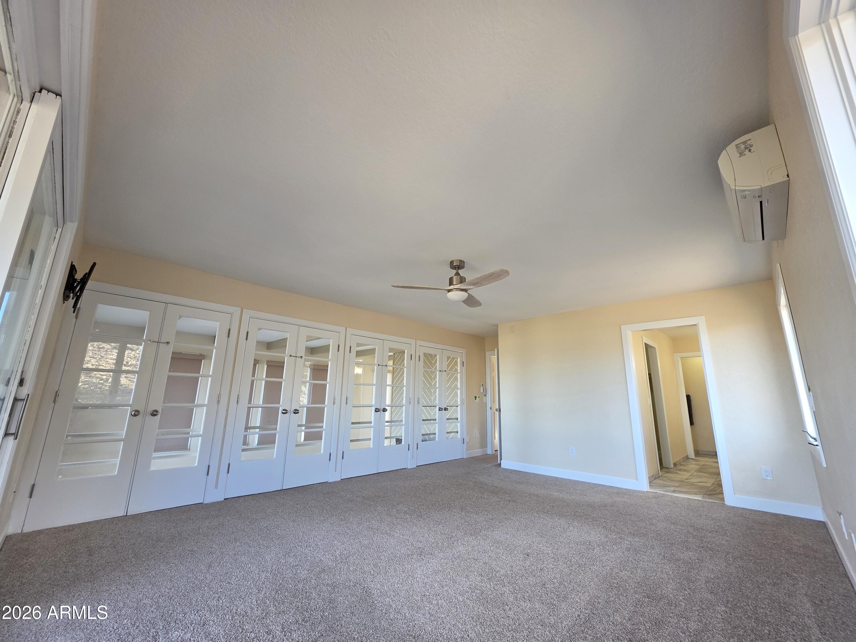 4880 Comanche Trail Prescott, AZ 86301 - Photo 27 of 44 a view of an empty room with wooden floor and a window
