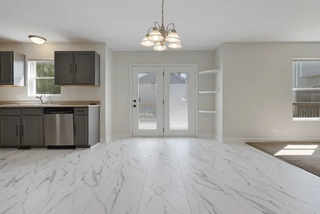 a spacious bathroom with a granite countertop sink a mirror and a shower