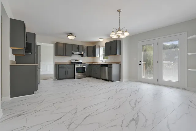 a large kitchen with a refrigerator and a sink