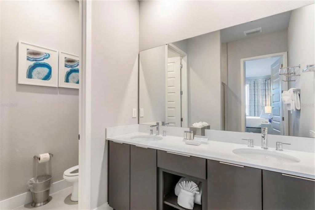 7760 Sandy Ridge Drive, Unit 108 Reunion, FL 34747 - Photo 11 of 16 a bathroom with a sink and a toilet