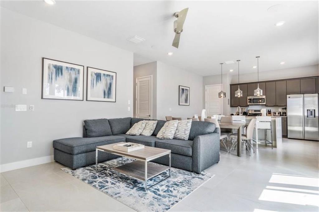 7760 Sandy Ridge Drive, Unit 108 Reunion, FL 34747 - Photo 12 of 16 a living room with furniture and kitchen view