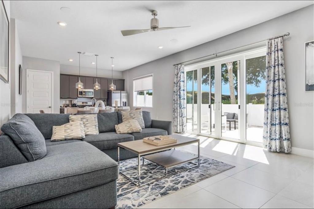 7760 Sandy Ridge Drive, Unit 108 Reunion, FL 34747 - Photo 2 of 16 a living room with furniture and a large window