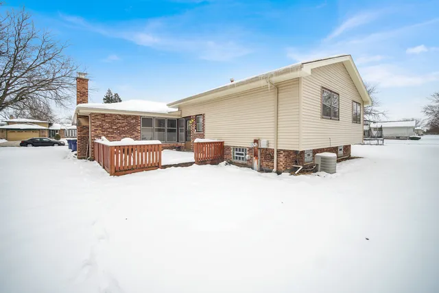 a view of a house with a snow in the yard