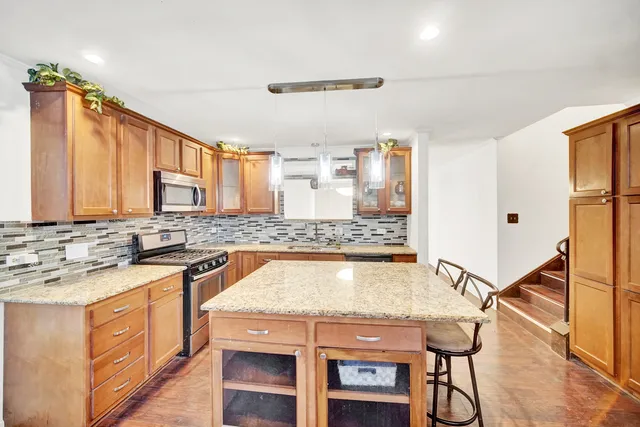 a kitchen with a stove a sink and a refrigerator