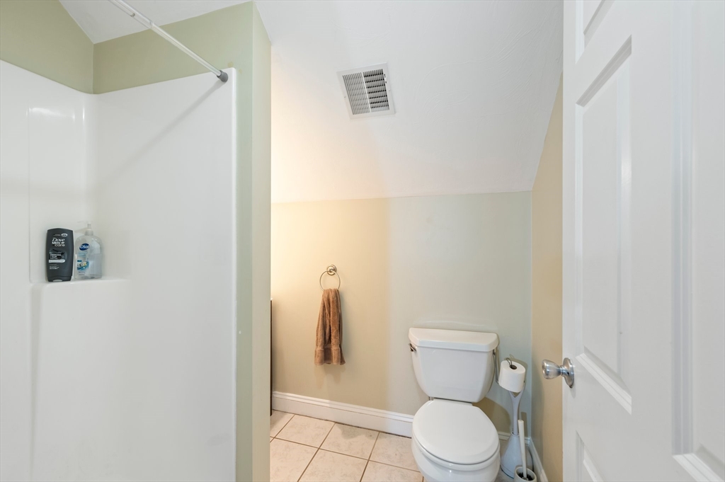 496 Main Street, Unit 2 Hanson, MA 02341 - Photo 16 of 20 a white toilet sitting next to a white sink