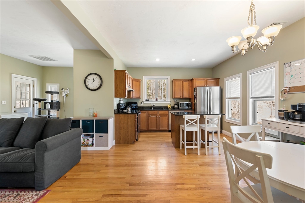 496 Main Street, Unit 2 Hanson, MA 02341 - Photo 3 of 20 a living room with furniture kitchen and a table