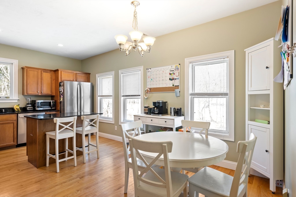 496 Main Street, Unit 2 Hanson, MA 02341 - Photo 4 of 20 a view of a dining room with furniture window and wooden floor