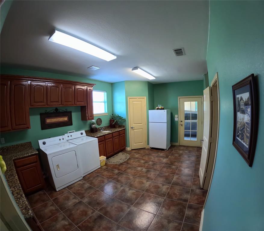 6401 County Road 3208 Lone Oak, TX 75453 - Photo 19 of 26 a room with furniture a flat screen tv and a refrigerator