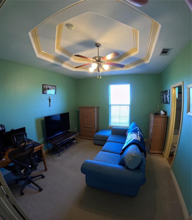 6401 County Road 3208 Lone Oak, TX 75453 - Photo 22 of 26 a living room with furniture a ceiling fan and a window