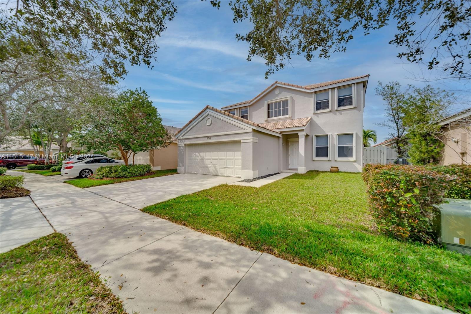 958 Briar Ridge Road Weston, FL 33327 - Photo 1 of 55 a front view of a house with a garden