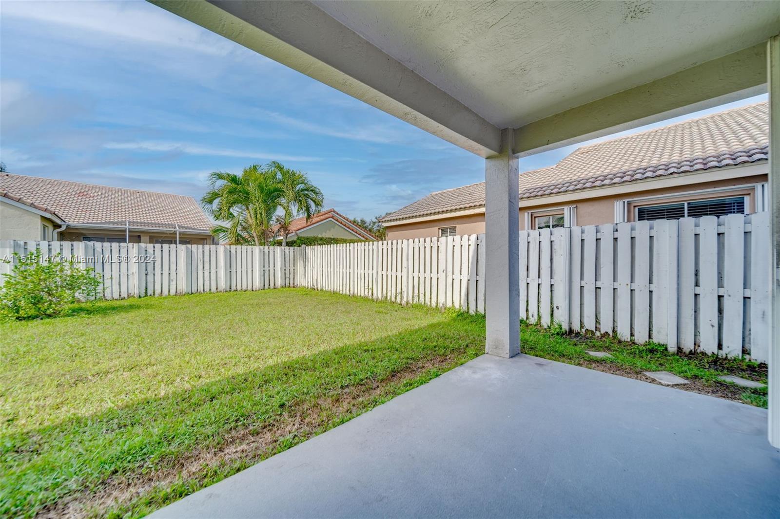 958 Briar Ridge Road Weston, FL 33327 - Photo 16 of 55 a view of a backyard with grass