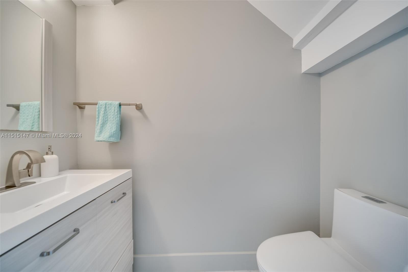 958 Briar Ridge Road Weston, FL 33327 - Photo 19 of 55 a bathroom with a toilet sink and mirror