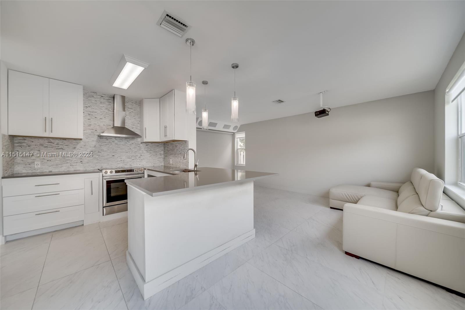 958 Briar Ridge Road Weston, FL 33327 - Photo 2 of 55 a kitchen with white cabinets a sink and white appliances
