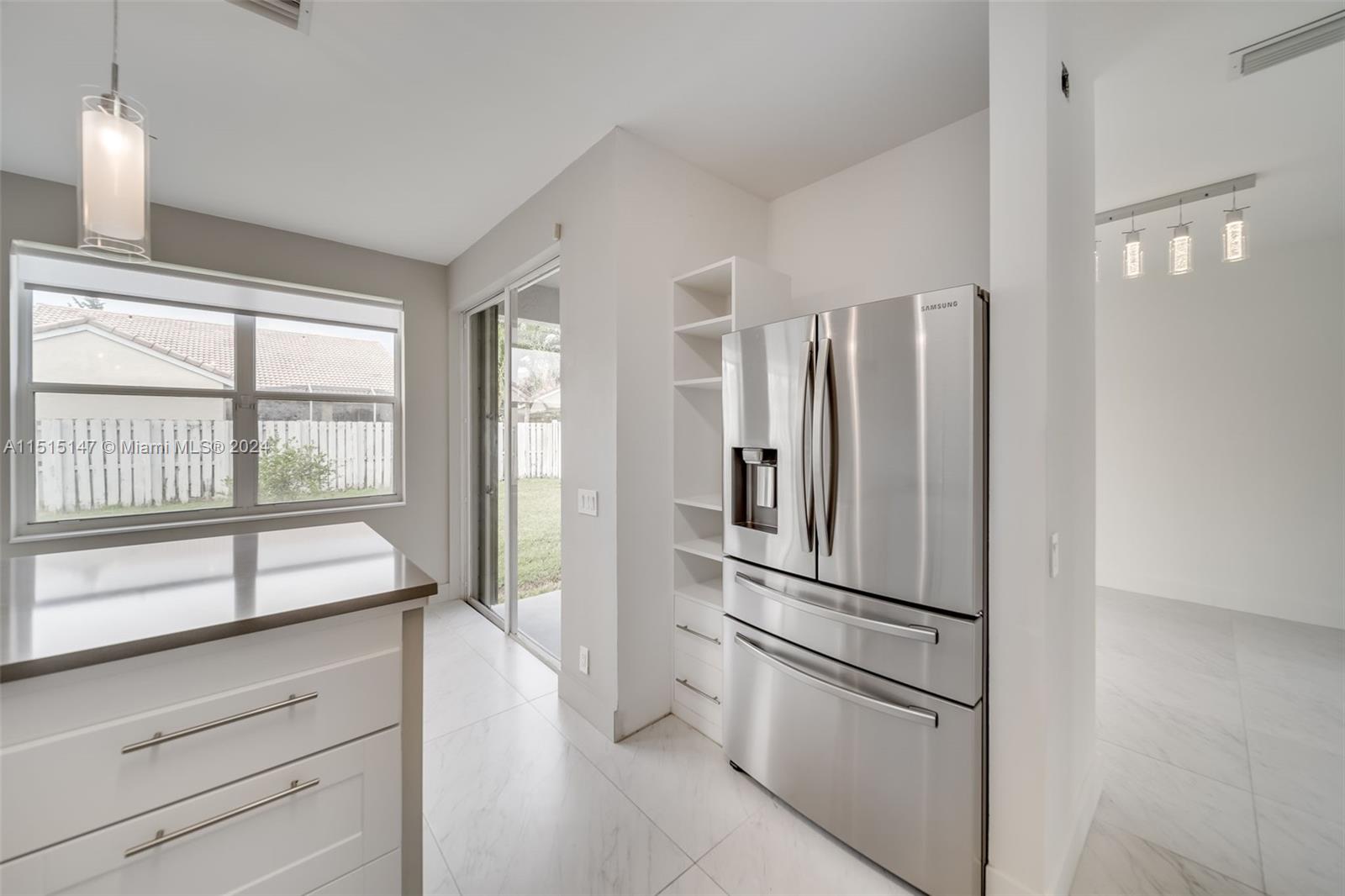 958 Briar Ridge Road Weston, FL 33327 - Photo 27 of 55 a kitchen with stainless steel appliances a refrigerator and a window