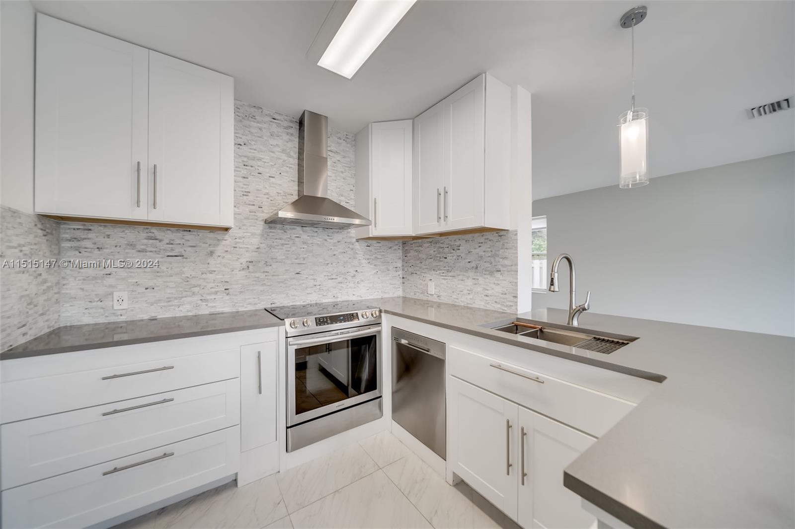 958 Briar Ridge Road Weston, FL 33327 - Photo 28 of 55 a kitchen with cabinets stainless steel appliances and sink
