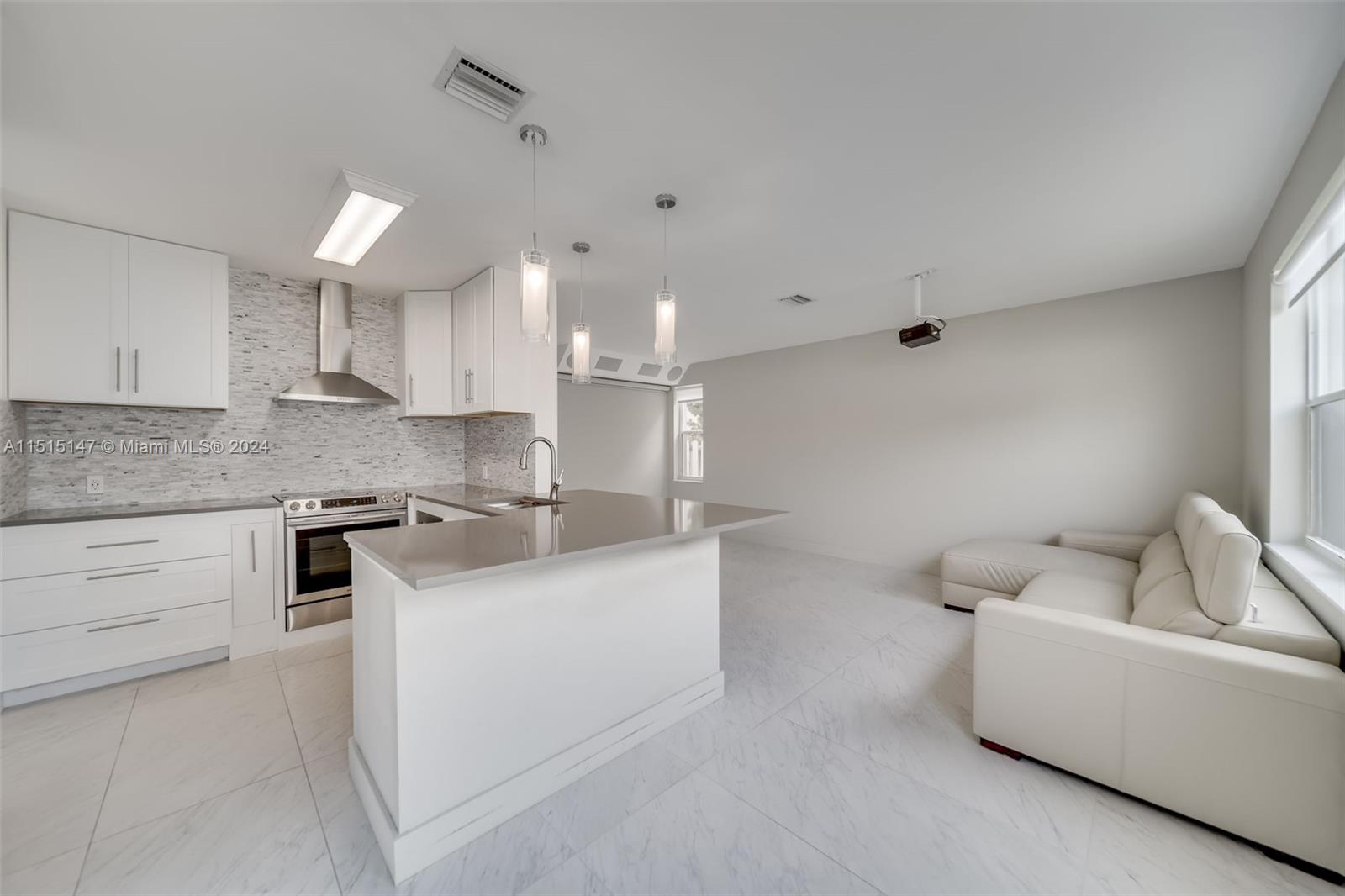 958 Briar Ridge Road Weston, FL 33327 - Photo 29 of 55 a kitchen with stainless steel appliances a sink a stove a refrigerator and white cabinets