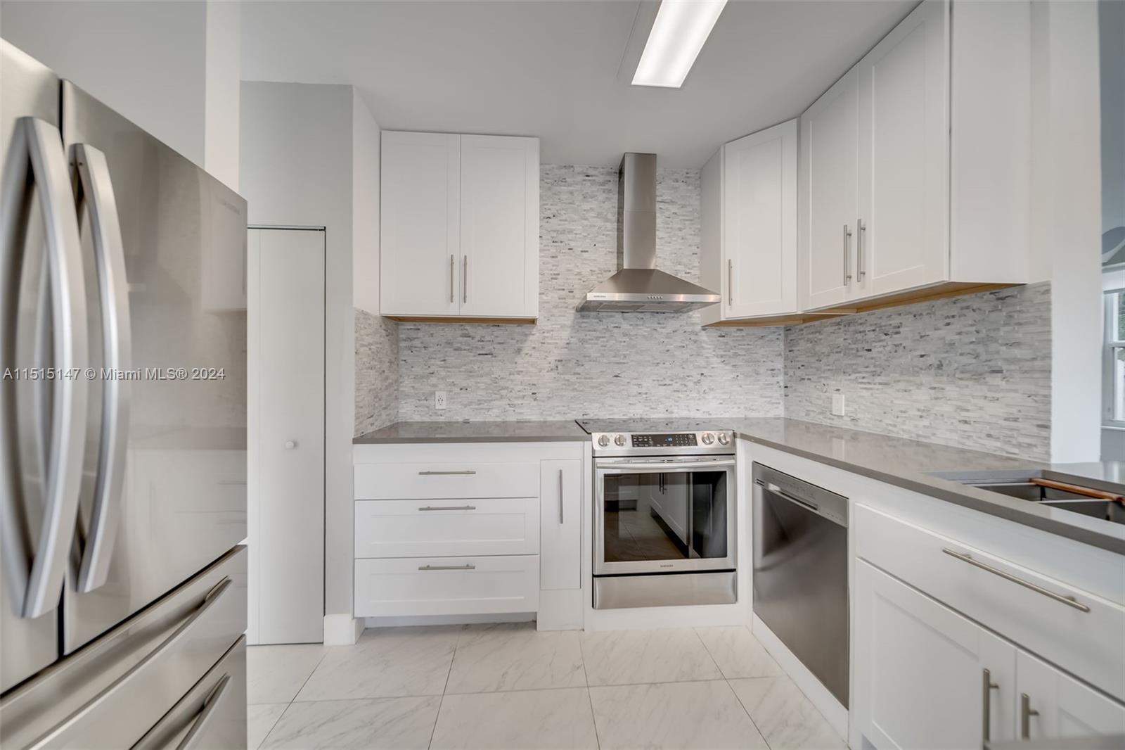 958 Briar Ridge Road Weston, FL 33327 - Photo 3 of 55 a kitchen with cabinets stainless steel appliances and counter space