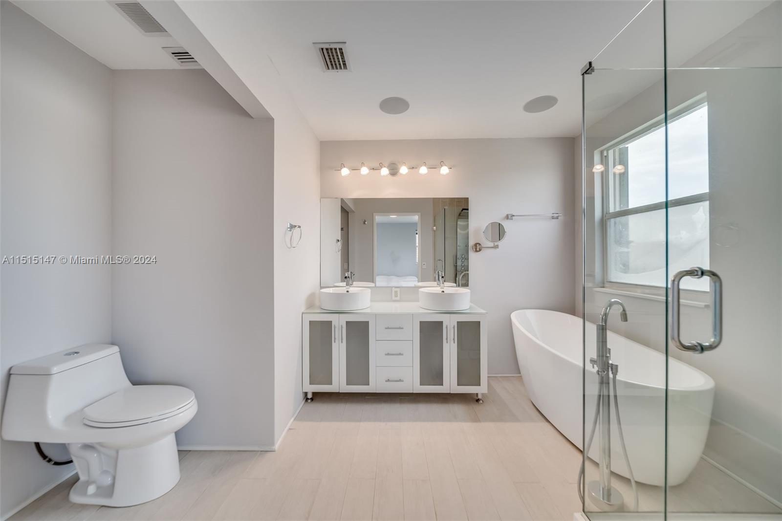 958 Briar Ridge Road Weston, FL 33327 - Photo 38 of 55 a spacious bathroom with a toilet sink and mirror