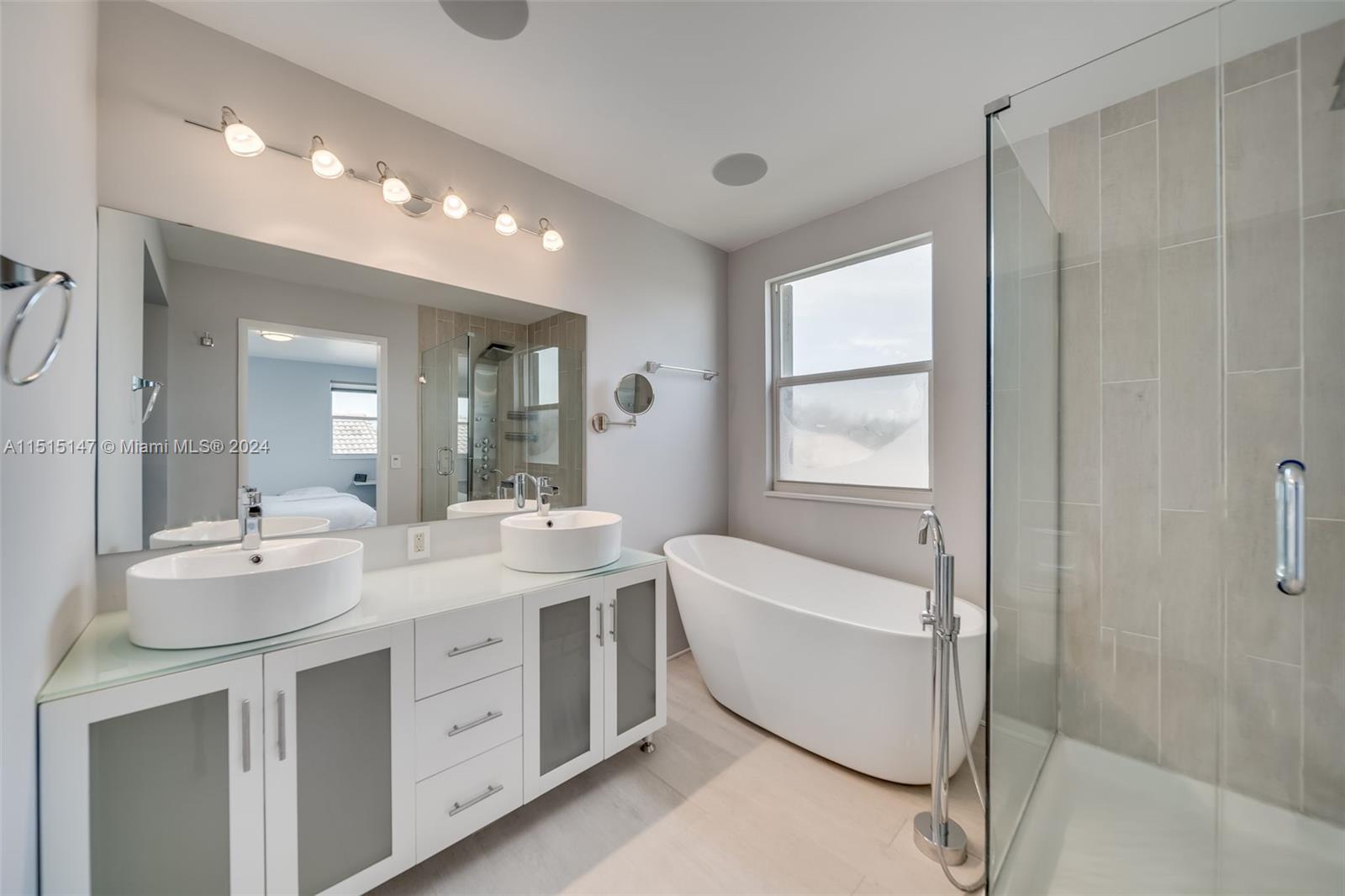 958 Briar Ridge Road Weston, FL 33327 - Photo 39 of 55 a bathroom with a double vanity sink mirror and bathtub