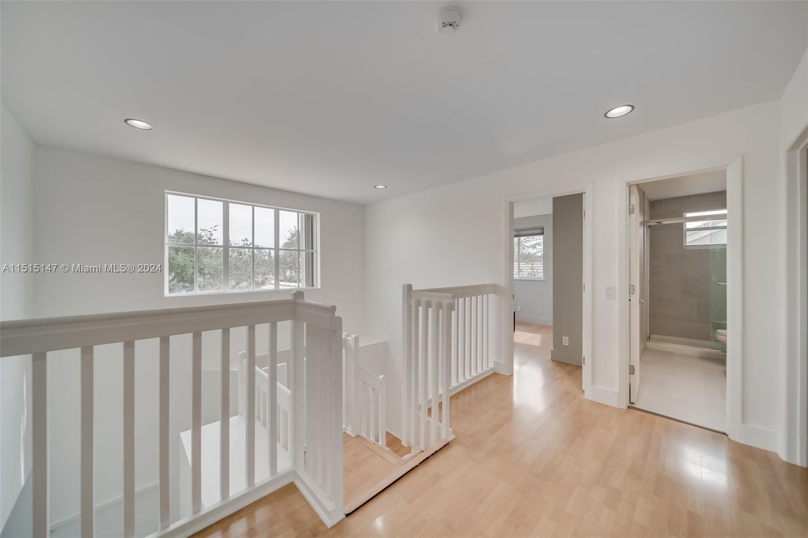958 Briar Ridge Road Weston, FL 33327 - Photo 47 of 55 a view of a room with wooden floor and windows