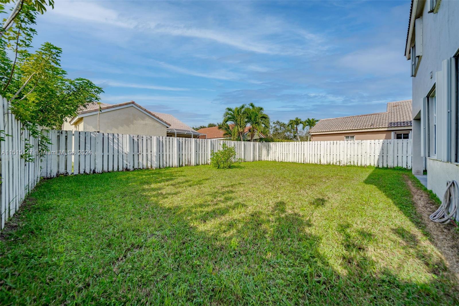 958 Briar Ridge Road Weston, FL 33327 - Photo 51 of 55 a view of a house with a big yard and a garden