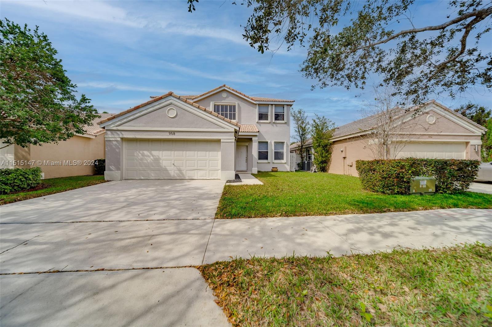 958 Briar Ridge Road Weston, FL 33327 - Photo 53 of 55 a front view of a house with a yard and garage
