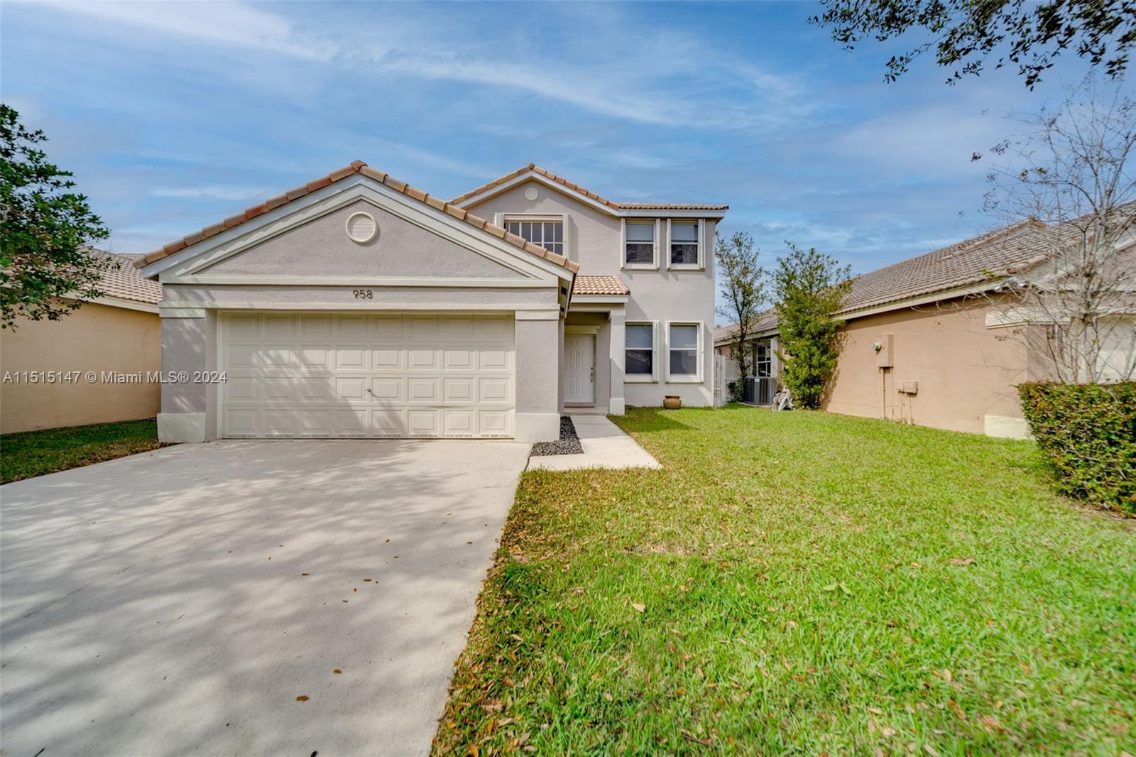 958 Briar Ridge Road Weston, FL 33327 - Photo 54 of 55 a front view of a house with a yard and garage