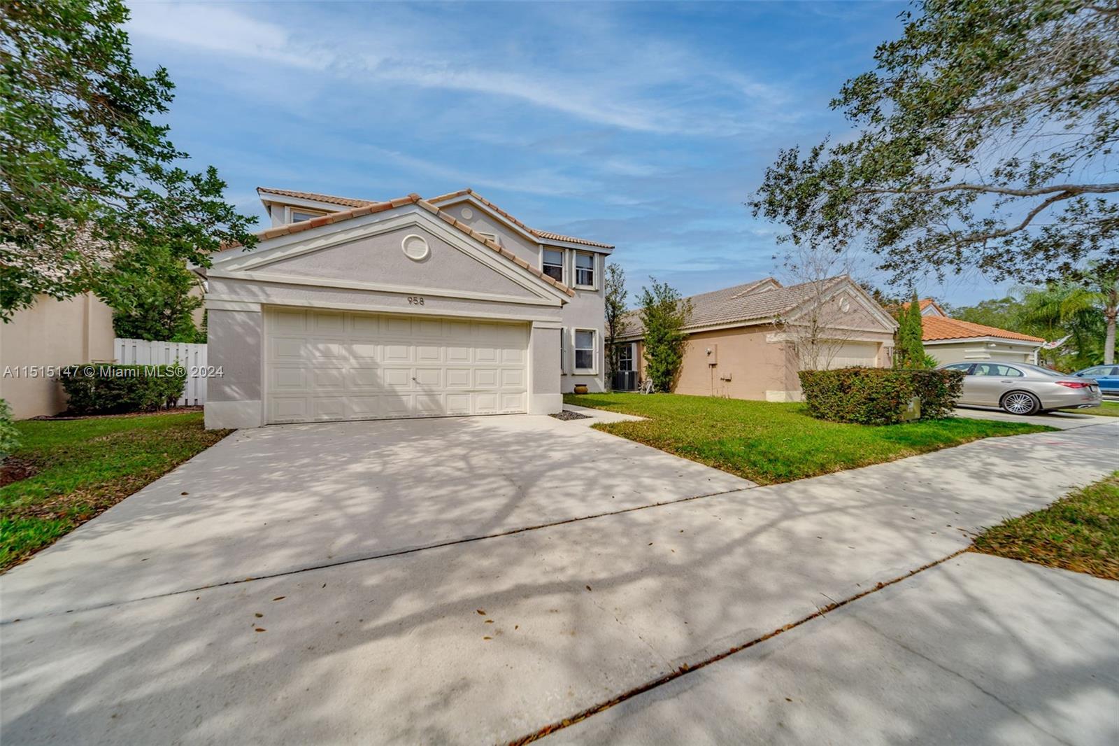 958 Briar Ridge Road Weston, FL 33327 - Photo 55 of 55 a front view of a house with a yard and garage