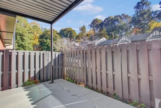a view of a backyard with wooden fence
