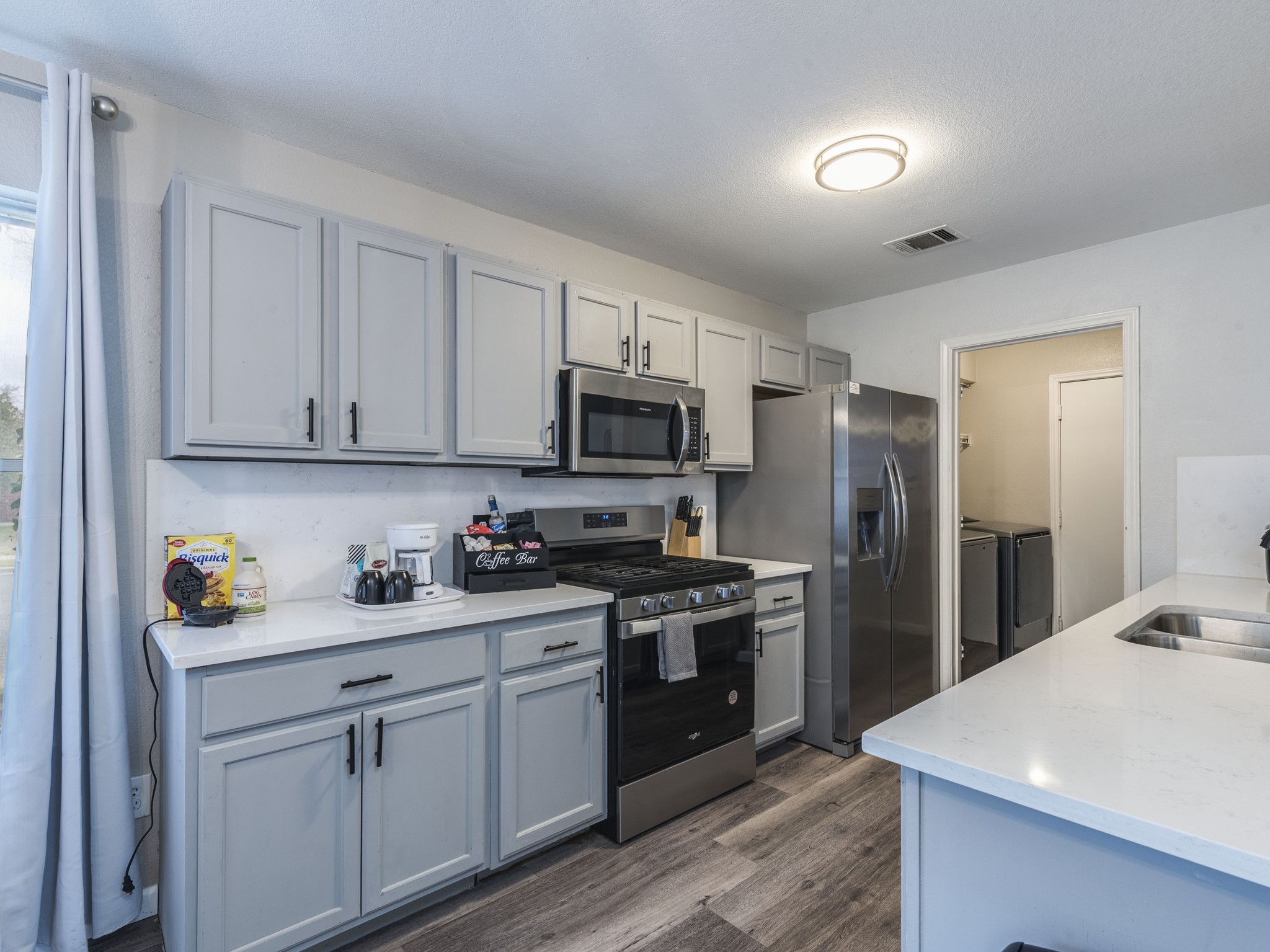 1415 Roxanne's Run Pflugerville, TX 78660 - Photo 12 of 30 Modern kitchen with sleek stainless steel appliances and ample counter space.