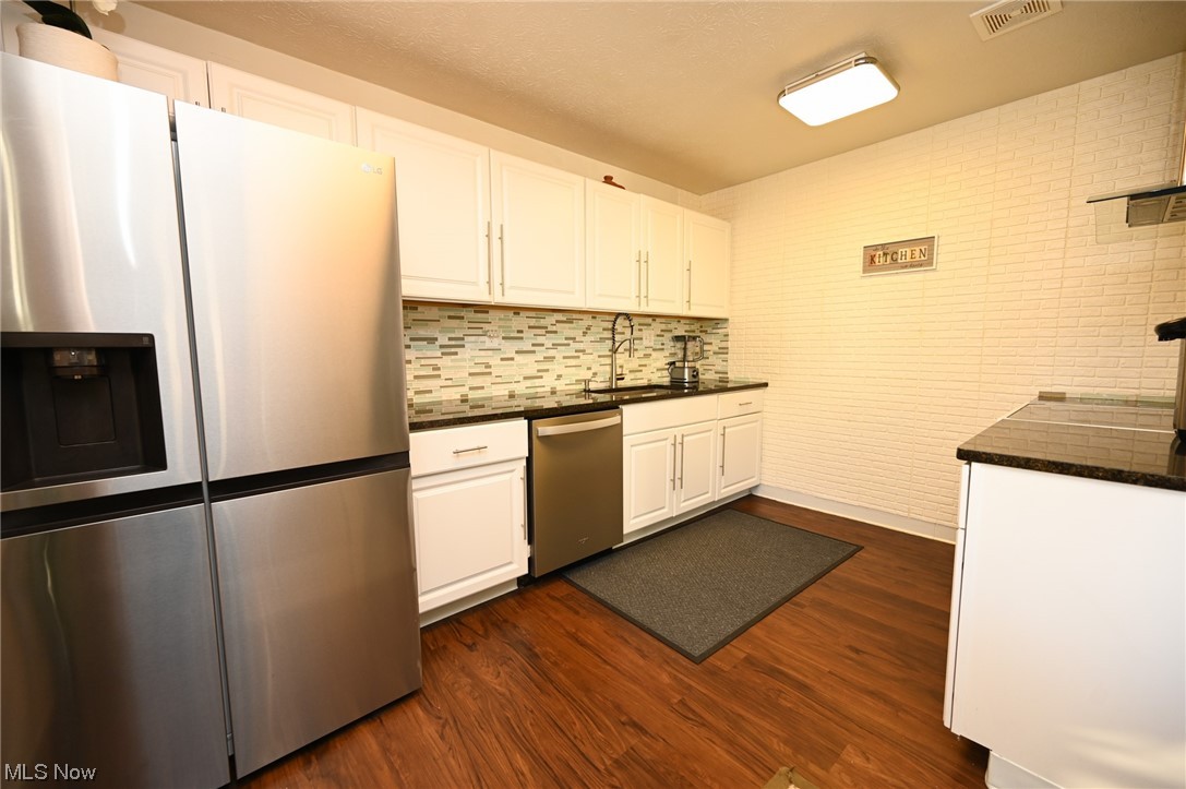 5651 Broadview Road, Unit C9 Cleveland, OH 44134 - Photo 6 of 29 Kitchen with appliances with stainless steel finishes, dark hardwood / wood-style flooring, and white cabinets