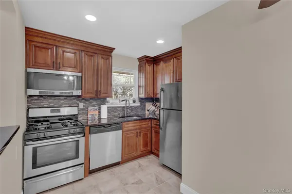 a kitchen with stainless steel appliances a stove sink and cabinets